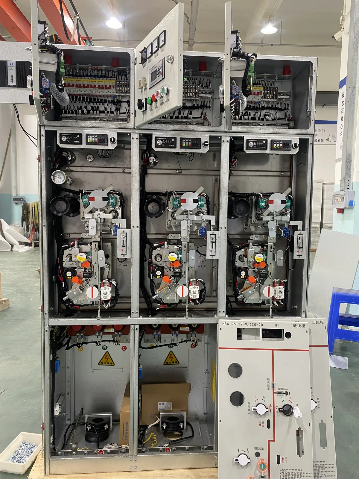 Open medium-voltage switchgear cabinet showing internal compartments and operating mechanisms