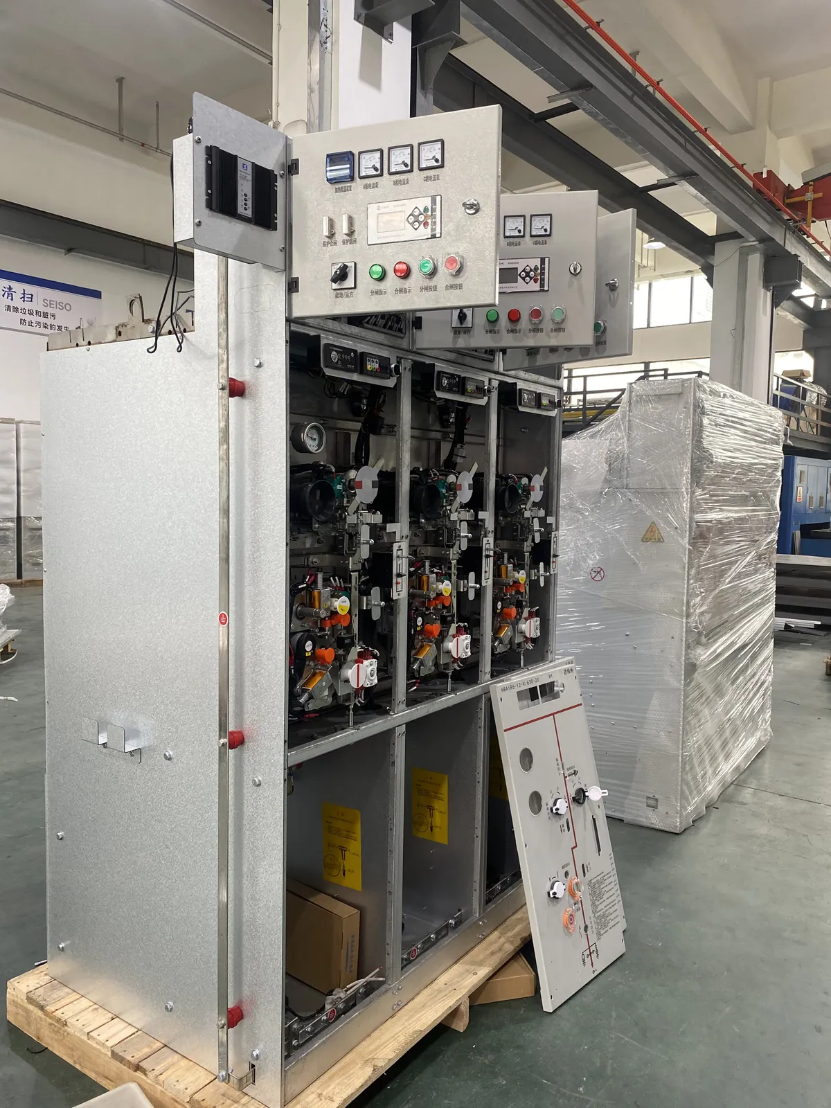 Gas-insulated switchgear cabinet with the front panel removed during assembly