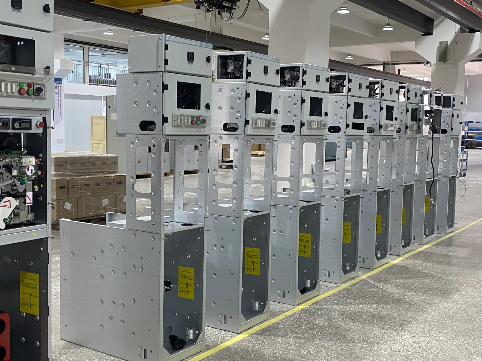 Medium-voltage switchgear cabinets staged on the factory floor for assembly and inspection
